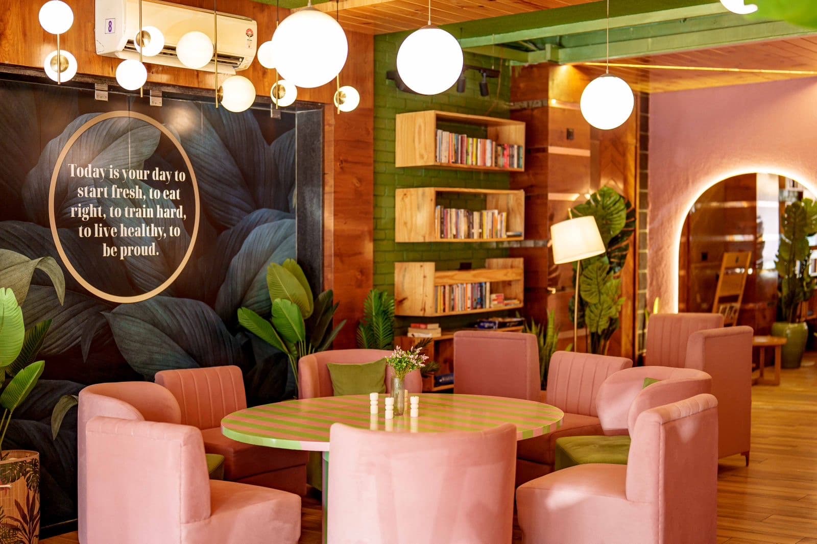 Inspirational quote wall with pink armchairs